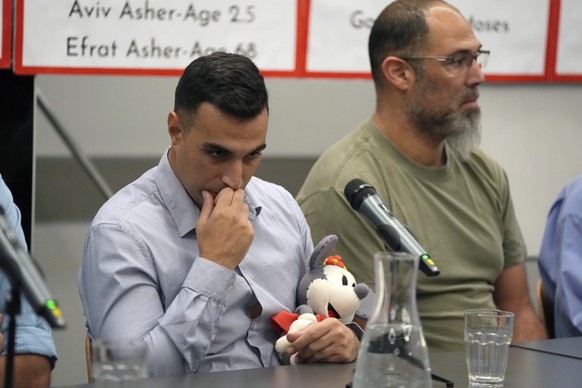 Yoni Asher holds a stuffed toy belonging to his daughter, who is missing along with other family members from Kibbutz Nir Oz, Tuesday Oct. 17, 2023 in Tel Aviv. Relatives of Israelis who are missing a ...