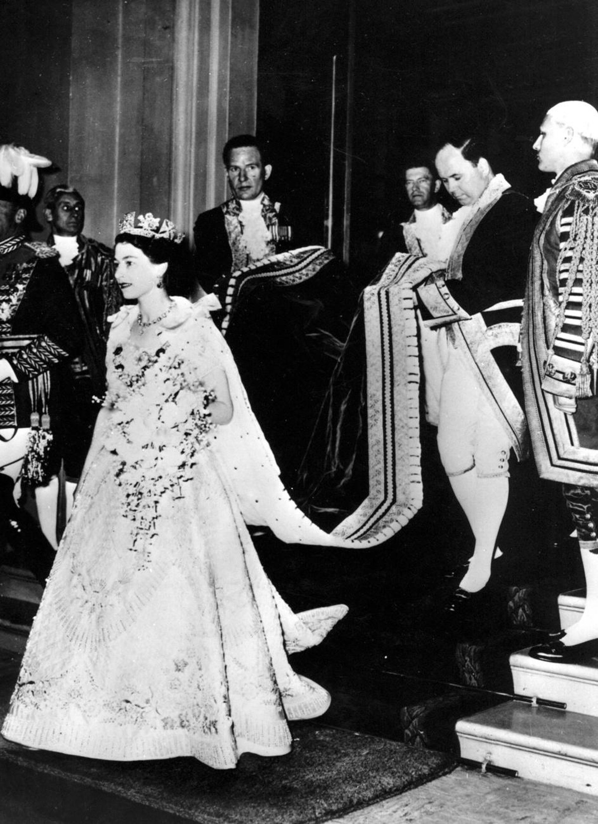 Coronation of Queen Elizabeth II. in London on June 2, 1953: The Queen's train is lifted by a footman as she leaves Buckingham Palace to enter the state coach to drive to Westminster Abbey for th ...