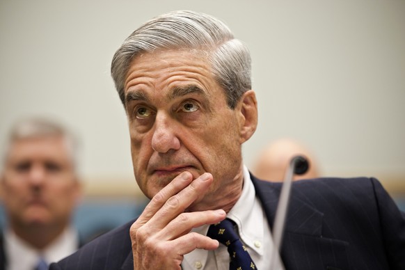 FILE - In this June 13, 2012, file photo then-FBI Director Robert Mueller listens as he testifies on Capitol Hill in Washington. Mueller took office as FBI director in 2001 expecting to dig into drug  ...