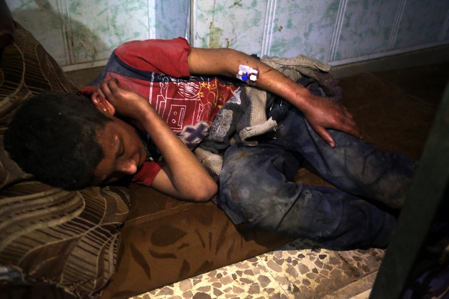 epa06655168 An injured victim of alleged chemical attack lies on the ground in rebels-held Douma, Syria, 08 April 2018. According to media and local reports, at least 70 people died after a helicopter ...