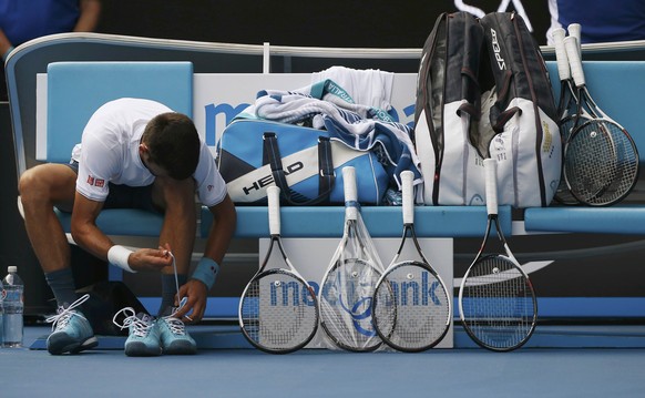 Tennis - Australian Open - Melbourne Park, Melbourne, Australia - 19/1/17 Serbia&#039;s Novak Djokovic changes his shoes while sitting next to his rackets during his Men&#039;s singles second round ma ...