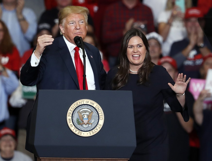 White House press secretary Sarah Huckabee Sanders, right, is introduced by President Donald Trump during a campaign rally Monday, Nov. 5, 2018, in Cape Girardeau, Mo. (AP Photo/Jeff Roberson)