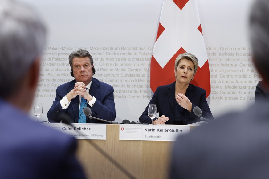 epa10532774 Swiss Finance Minister Karin Keller-Sutter (R), speaks next to Colm Kelleher (L), Chairman UBS, during a press conference in Bern, Switzerland, 19 March 2023. The bank UBS takes over Credi ...