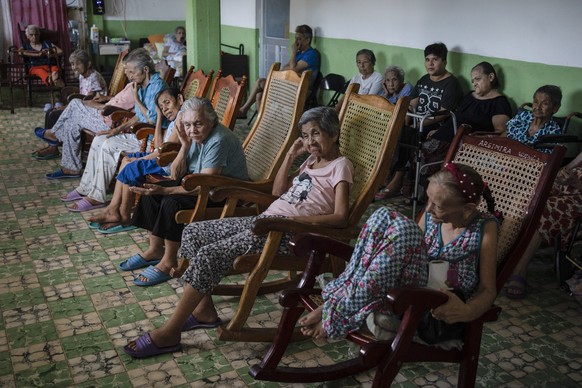 Isabel Rios, 73, center, sits with others by the window of the Cogra nursing home to cool off from the high temperatures in Veracruz, Mexico, Sunday, June 16, 2024. Victims in Veracruz have made up ne ...