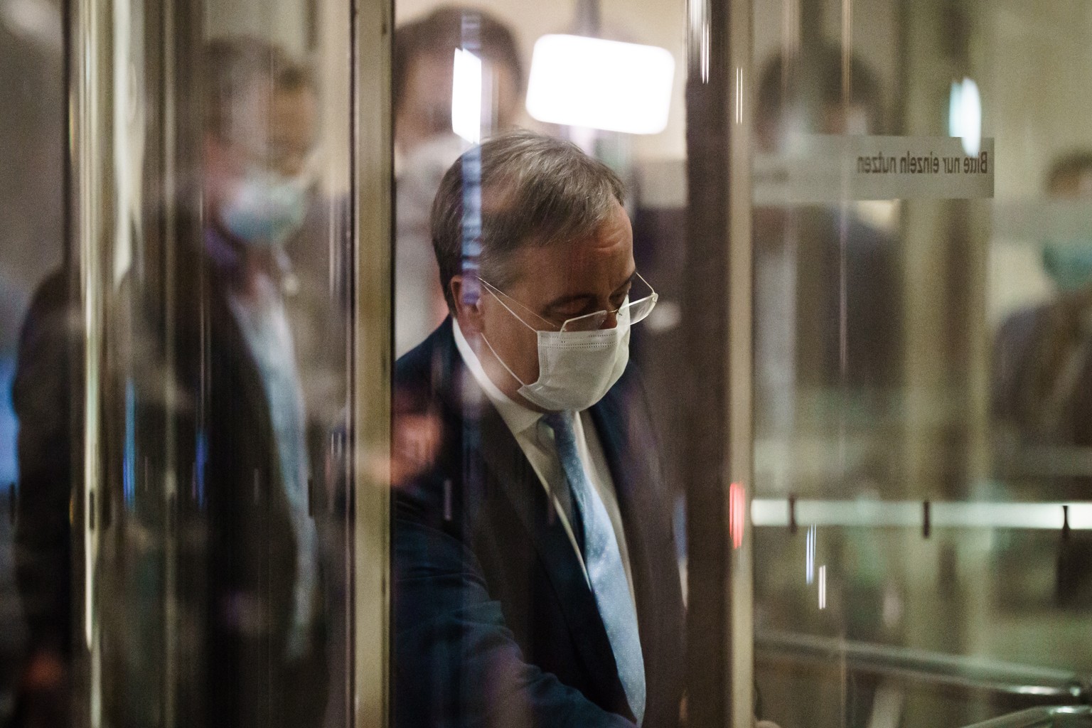 epa09493839 Christian Democratic Union (CDU) party chairman Armin Laschet is seen in flash light as he leaves the Reichstag building, the seat of the German Parliament, after a faction meeting of CDU  ...