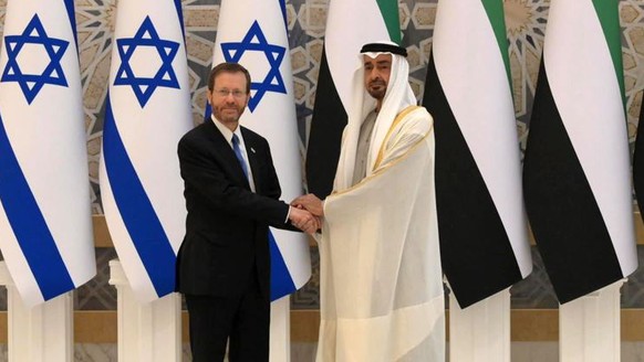 epa09718078 A handout photo made available by Israeli Government Press Office shows Israeli President Isaac Herzog (L) meeting with Crown Prince of Abu Dhabi, Sheikh Mohammed bin Zayed Al Nahyan, in A ...