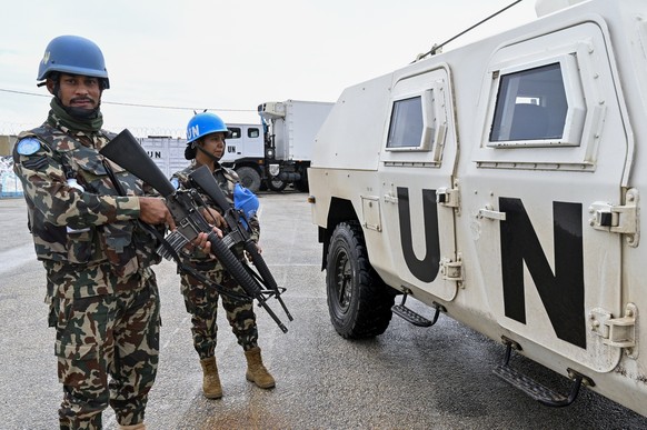 epa12578797 Members of Nepals UNIFIL peacekeeping forces stand next to their vehicle at the Nepbatt headquarters in Meiss al-Jabal, Marjayoun district, southern Lebanon, 08 December 2025. The UN Secu ...