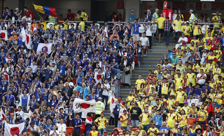 Japanese, left, and Colombian fans pack the stands near the end of the group H match between Colombia and Japan at the 2018 soccer World Cup in the Mordavia Arena in Saransk, Russia, Tuesday, June 19, ...