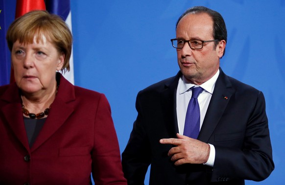 German Chancellor Angela Merkel and French President Francois Hollande leave a news conference after talks on a stalled peace plan for eastern Ukraine at the chancellery in Berlin, Germany, October 20 ...