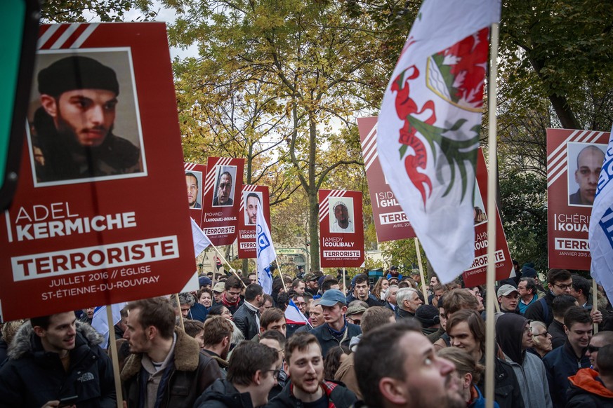 epa08003933 Members of far right group Generation Identitaire (GI) hold posters of terrorists who perpetrated attacks in France during a demonstration against &#039;Islamization and terrorism&#039; in ...