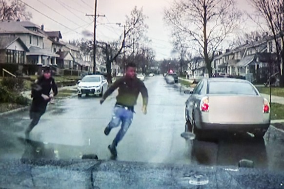 A TV display shows video evidence of a Grand Rapids police officer struggling with and shooting Patrick Lyoya at Grand Rapids City Hall on Wednesday, April 13, 2022. Lyoya, 26, was shot and killed abo ...