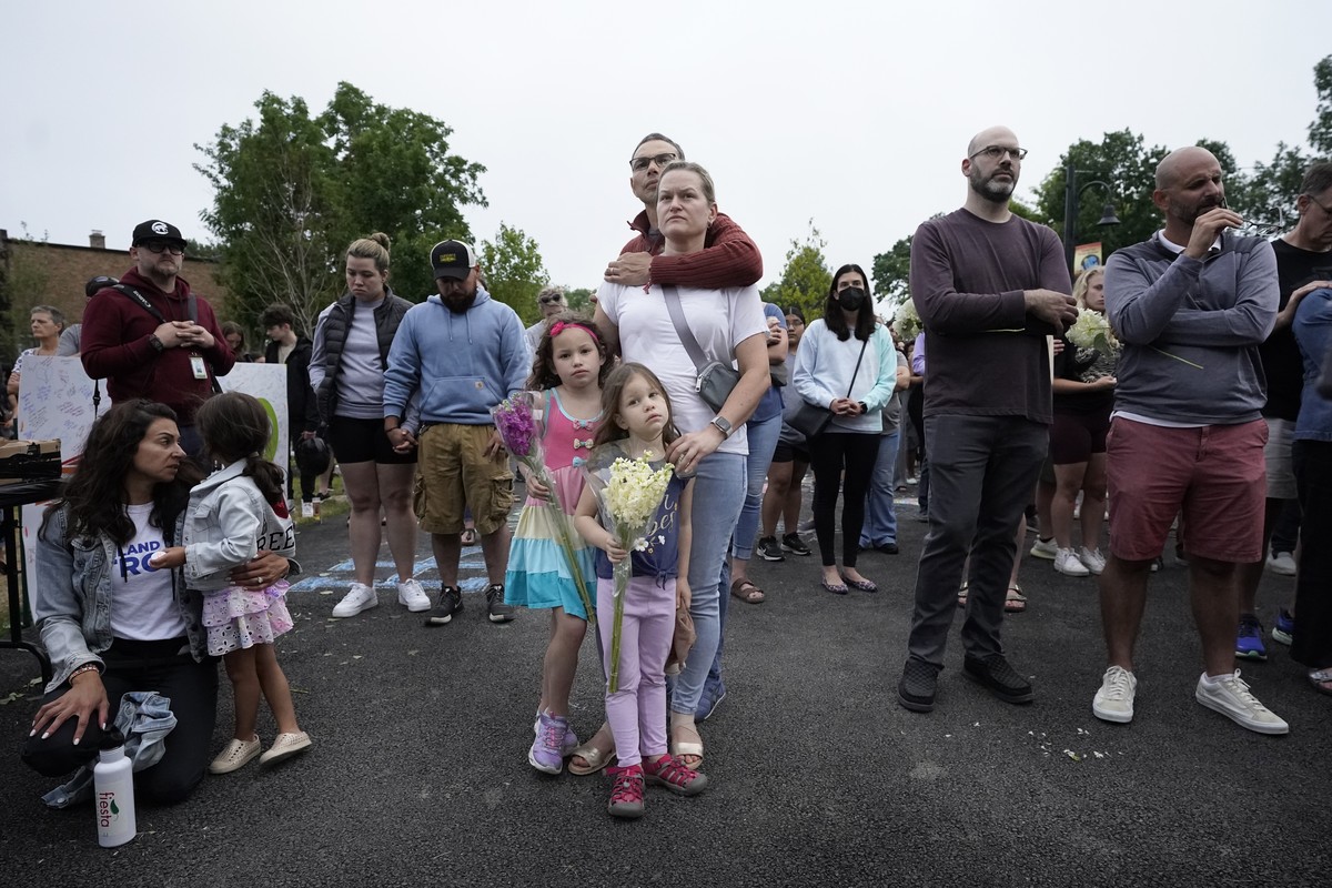 The Galbano family, from Highland Park, Ill., center, listens during a vigil in Highwood, Ill., for the victims of Monday's Highland Park's Fourth of July parade, Wednesday, July 6, 2022. (A ...