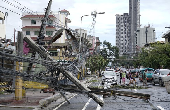 Toppled electrical posts lie along a street in Cebu city, central Philippines caused by Typhoon Rai on Friday, Dec. 17, 2021. A powerful typhoon slammed into the southeastern Philippines on Thursday,  ...