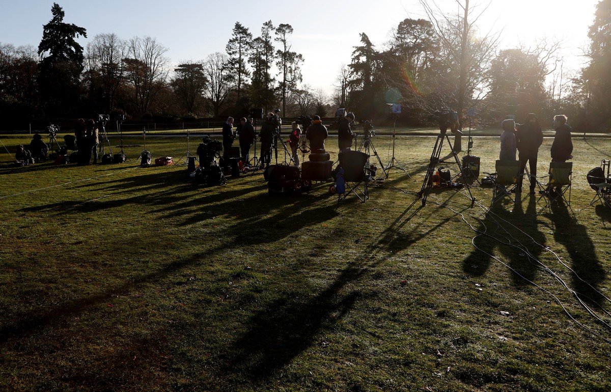 The media prepare at the entrance of Sandringham estate, Sandringham, England, early morning Monday, Jan. 13, 2020. Britain's Queen Elizabeth II is preparing for a crisis family meeting to work o ...