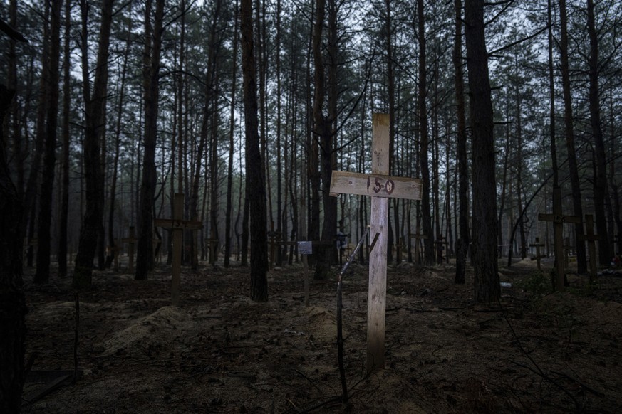 A view of unidentified graves of civilians and Ukrainian soldiers in a cemetery in the recently retaken area of Izium, Ukraine, Thursday, Sept. 15, 2022 who had been killed by Russian forces near the  ...