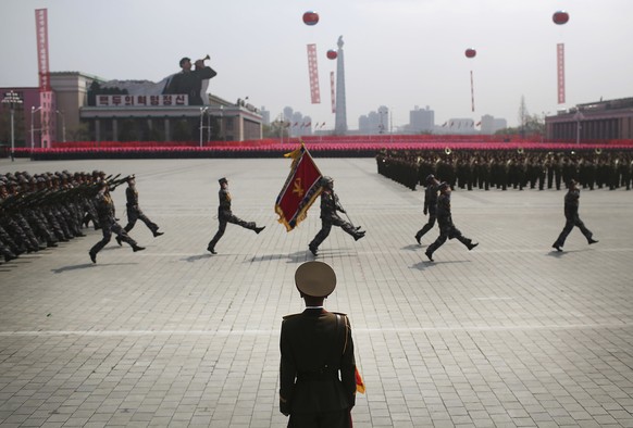 A soldier watches as others march across Kim Il Sung Square during a military parade on Saturday, April 15, 2017, in Pyongyang, North Korea to celebrate the 105th birth anniversary of Kim Il Sung, the ...