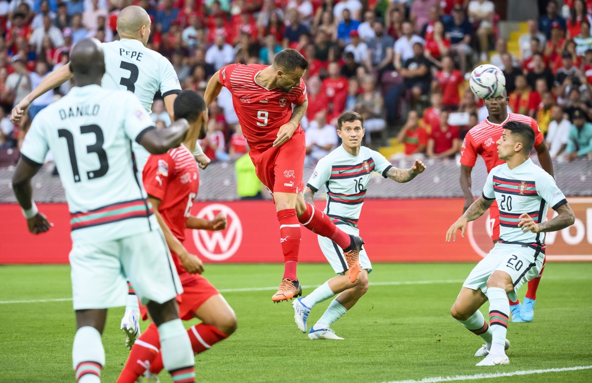 Switzerland's forward Haris Seferovic, center, scores the first goal during the UEFA Nations League group A2 soccer match between Switzerland and Portugal at the Stade de Geneve stadium, in Genev ...