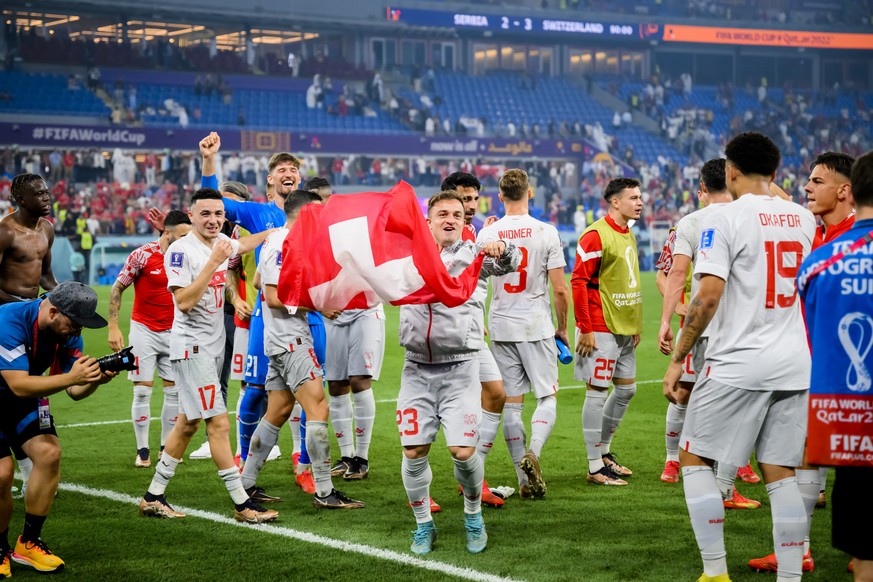 Switzerland's soccer players with Switzerland's midfielder Xherdan Shaqiri celebrate the victory and the qualification during the FIFA World Cup Qatar 2022 group G soccer match between Serbia and Swit ...