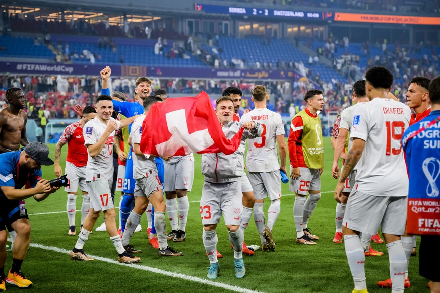 Switzerland&#039;s soccer players with Switzerland&#039;s midfielder Xherdan Shaqiri celebrate the victory and the qualification during the FIFA World Cup Qatar 2022 group G soccer match between Serbi ...