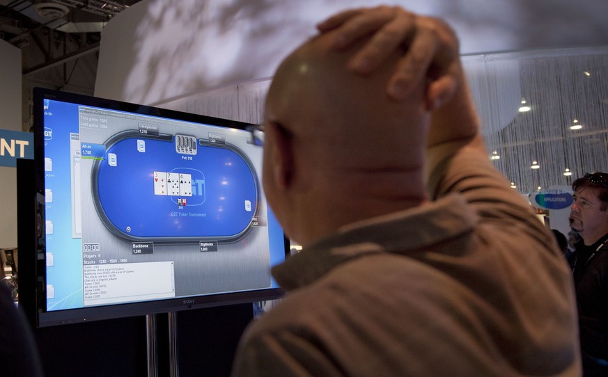 FILE - In an October, 2011, file photo casino industry representatives and exhibitors watch an online poker game at the industry&#039;s G2E gaming conference in Las Vegas. Internet gambling in the Uni ...