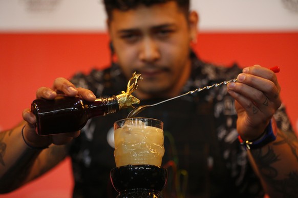 epa10533125 A bartender competes during the fifth edition of the Tequila Mixology Contest in Guadalajara, Mexico, 19 March 2023. The contest is held to highlight Mexican tequila and to showcase the sk ...