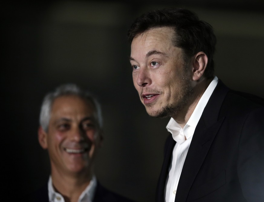 Chicago Mayor Rahm Emanuel, left, listens as Tesla CEO and founder of the Boring Company Elon Musk, right, speaks at a news conference Thursday, June 14, 2018, in Chicago. The Boring Company has been  ...