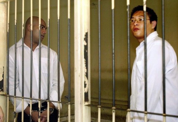 Australian Andrew Chan, right, and, and Myuran Sukumaran, left, stand inside a holding cell after their trial at a court in Denpasar, Bali, Indonesia, Tuesday, Feb. 14, 2006. The two Australians were  ...
