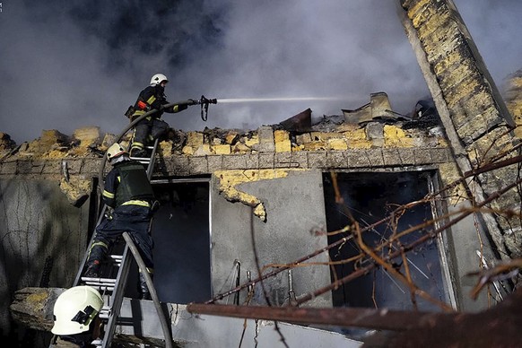 In this photo provided by the Ukrainian Emergency Service, firefighters work on the site of a burning building after a Russian attack in Odesa, Ukraine, Friday, Feb. 23, 2024. (Ukrainian Emergency Ser ...