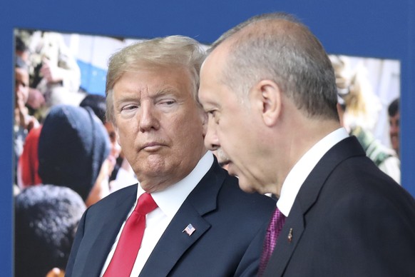 FILE - In this July 11, 2018 file photo, President Donald Trump, left, talks to Turkish President Recep Tayyip Erdogan as they tour the new NATO headquarters in Brussels, Belgium. Trump’s decision to  ...