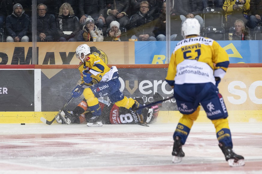 der Davoser Spieler Enzo Guebey, oben, macht einen Fehler auf der Berner Spieler Joshua Fahrni, unten, beim Eishockey Meisterschaftsspiel der National League zwischen dem SC Bern und HC Davos, am Mitt ...