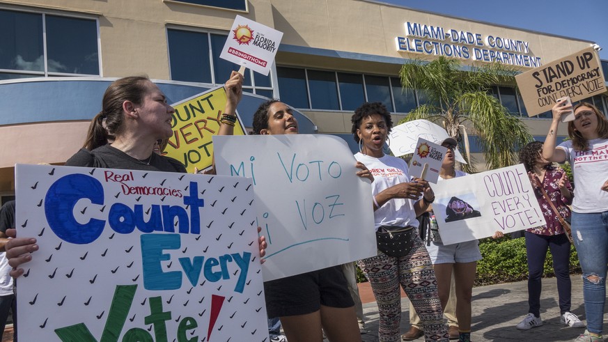epaselect epa07155902 A crowd protests to demand a vote recount outside the Miami-Dade Election Department in Miami, Florida, USA on 10 November 2018. A possible recount looms in a tight Florida gover ...