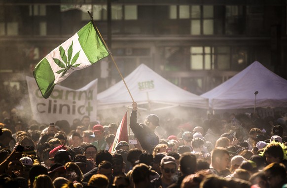 FILE- In this April 20, 2016, file photo, people smoke marijuana during a 4/20 cannabis culture rally in Toronto. The Canadian government, which introduced nationwide pot legalization legislation last ...