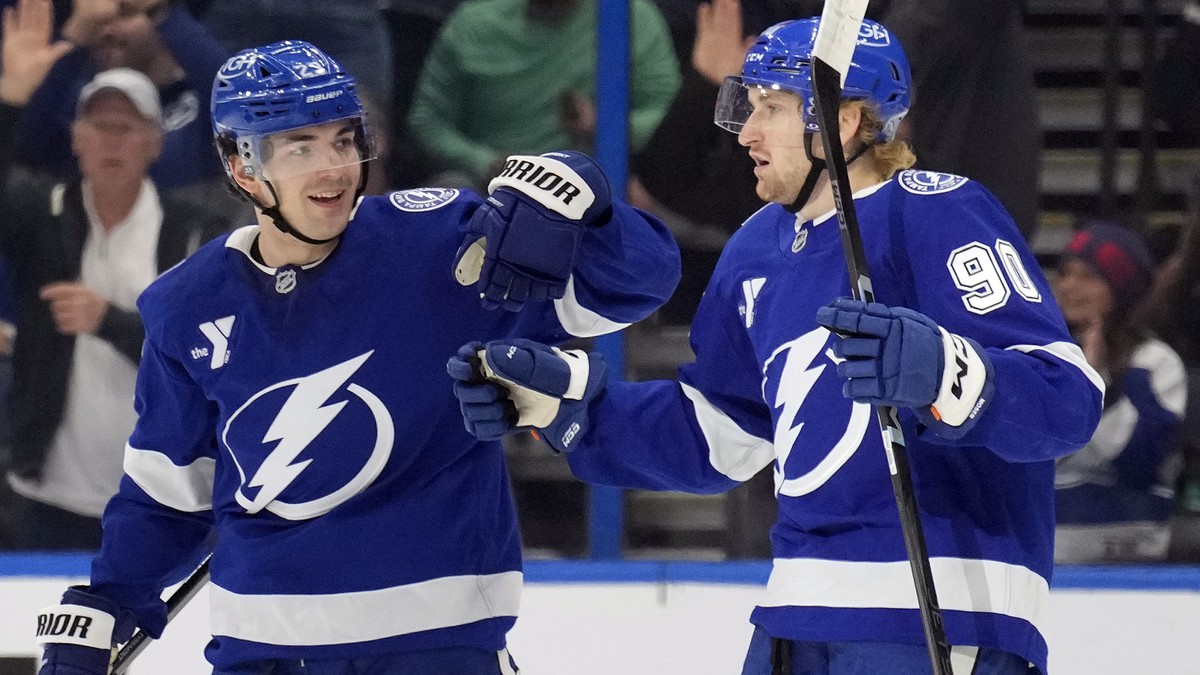 Tampa Bay Lightning defenseman Janis Moser (90) celebrates his goal against the Vegas Golden Knights with center Michael Eyssimont (23) during the first period of an NHL hockey game Thursday, Oct. 17, ...