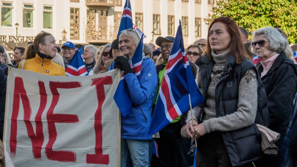 People hold a banner reading "No" as they listen to speakers at an "Afram Island," "Forward, Iceland," rally opposing the resumption of European Union accession talks at  ...