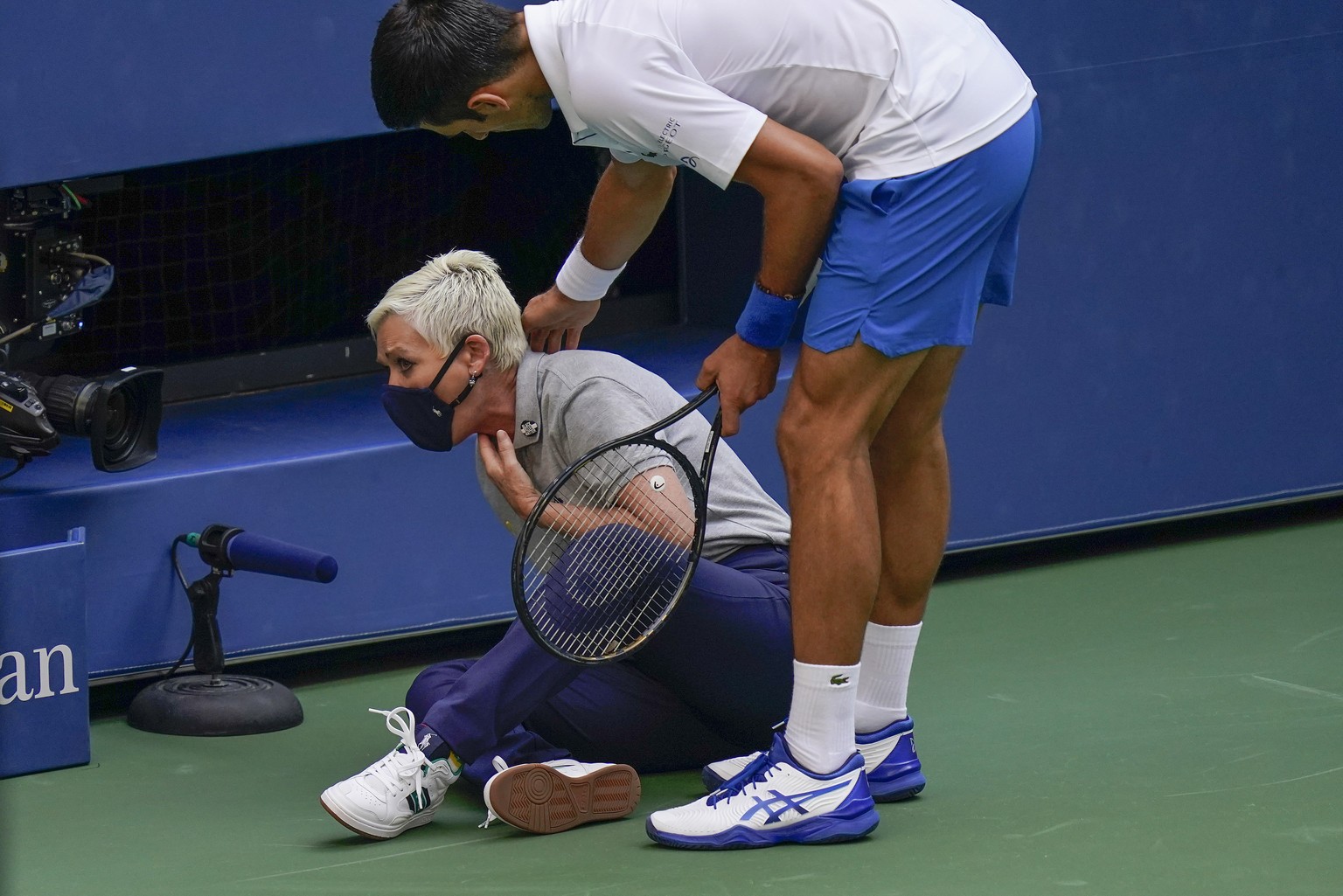 Novak Djokovic, of Serbia, checks a linesman after hitting her with a ball in reaction to losing a point to Pablo Carreno Busta, of Spain, during the fourth round of the US Open tennis championships,  ...