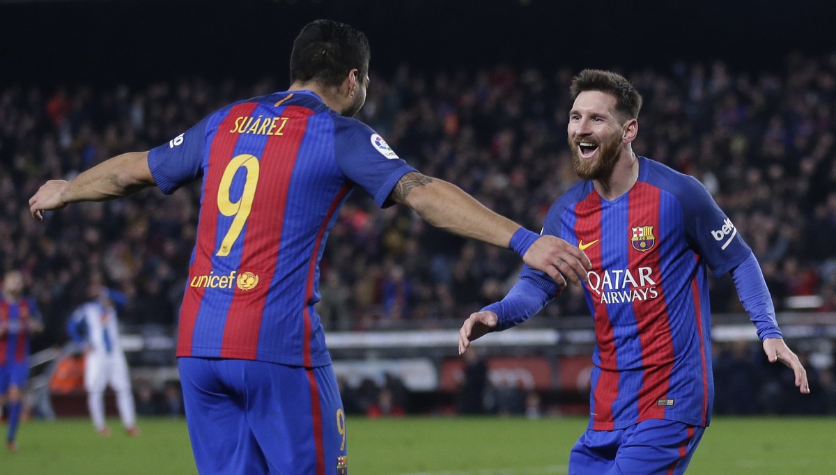 FC Barcelona's Lionel Messi, right, celebrates after scoring with his teammate Luis Suarez during the Spanish La Liga soccer match between FC Barcelona and Espanyol at the Camp Nou in Barcelona,  ...
