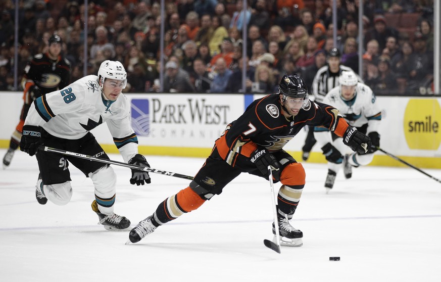 Anaheim Ducks&#039; Andrew Cogliano moves the puck past San Jose Sharks&#039; Timo Meier, of Switzerland, during the second period of an NHL hockey game Sunday, Jan. 21, 2018, in Anaheim, Calif. (AP P ...