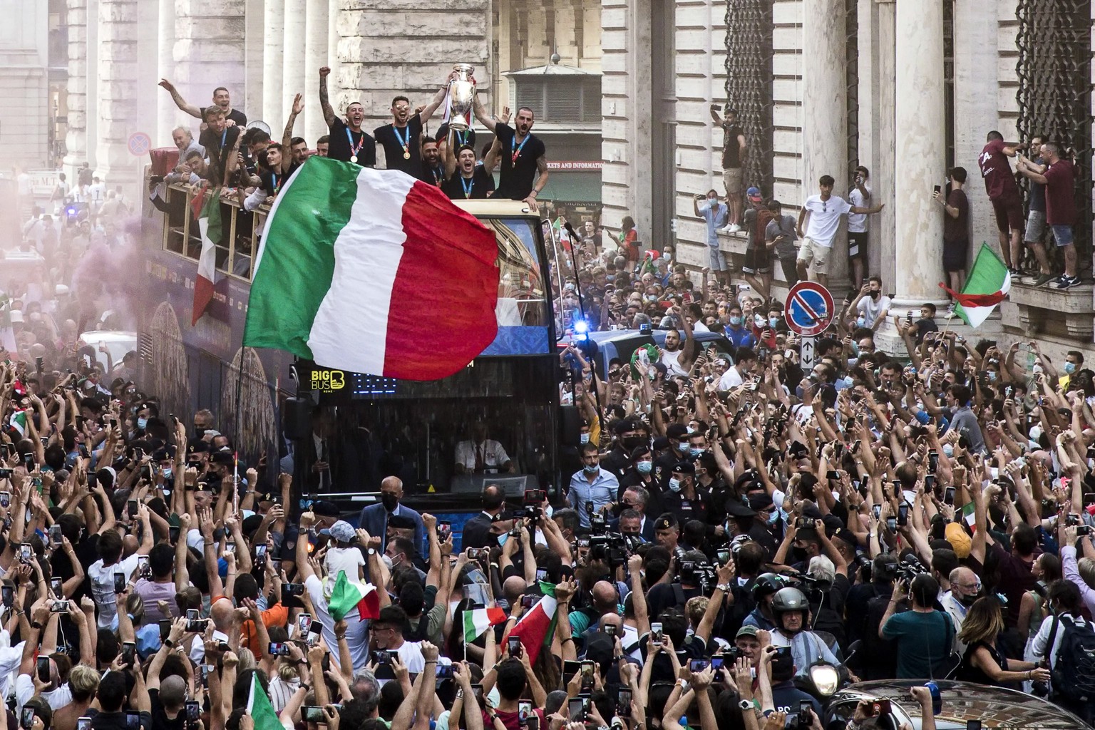 epa09340812 The Italian national football team in an open-top coach in via del Corso as fans celebrate after they returned from London after winning the UEFA EURO 2020 championship, Rome, Italy, 12 Ju ...