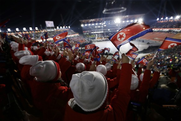 Members of the North Korean delegation wave flags before the opening ceremony of the 2018 Winter Olympics in Pyeongchang, South Korea, Friday, Feb. 9, 2018. (AP Photo/Natacha Pisarenko)