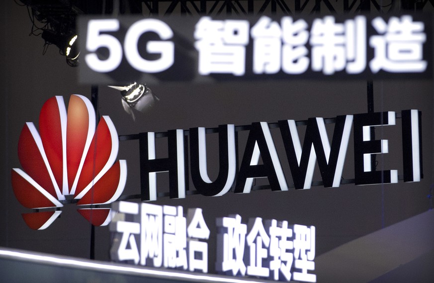 FILE - In this Sept. 26, 2018, file photo, signs promoting 5G wireless technology from Chinese technology firm Huawei are displayed at the PT Expo in Beijing. The Federal Network Agency in Germany iss ...