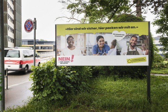 Ein Plakat der Schweizerischen Fluechtlingshilfe wirbt fuer ein Nein zur Nachhaltigkeits-Initiative, Keine 10-Millionen-Schweiz! der SVP, fotografiert am Montag, 18. Mai 2026 in Bern. (KEYSTONE/Christ ...
