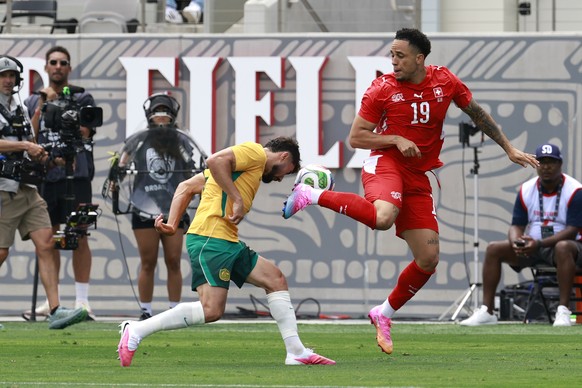 Switzerland's Noah Okafor, right, and Australia's Jacob Italiano in action during a friendly soccer match between Switzerland and Australia at the Snapdragon Stadium in San Diego, California ...