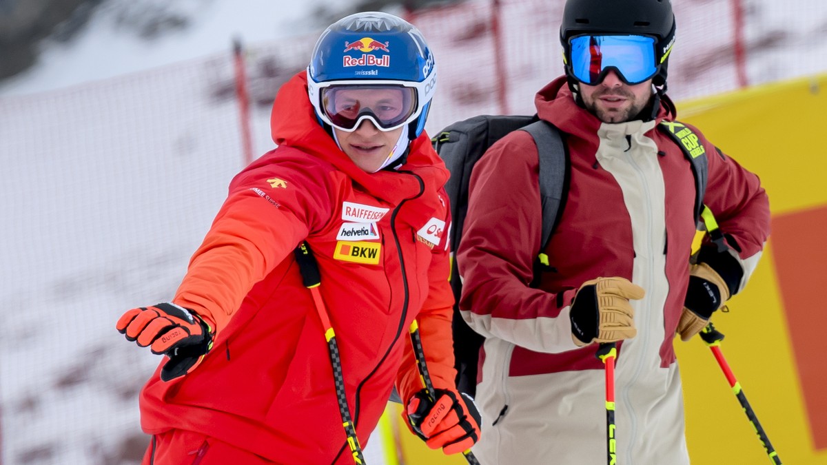 epa10965993 Marco Odermatt of Switzerland, left, inspects the slope with Beat Feuz former ski racer of Switzerland and consultant for Swiss TV SRF before the men's downhill training race on the n ...