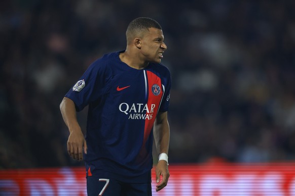 PSG&#039;s Kylian Mbappe grimaces after sustaining an injury during the French League One soccer match between Paris Saint Germain and Olympique de Marseille at Parc des Princes stadium in Paris, Fran ...