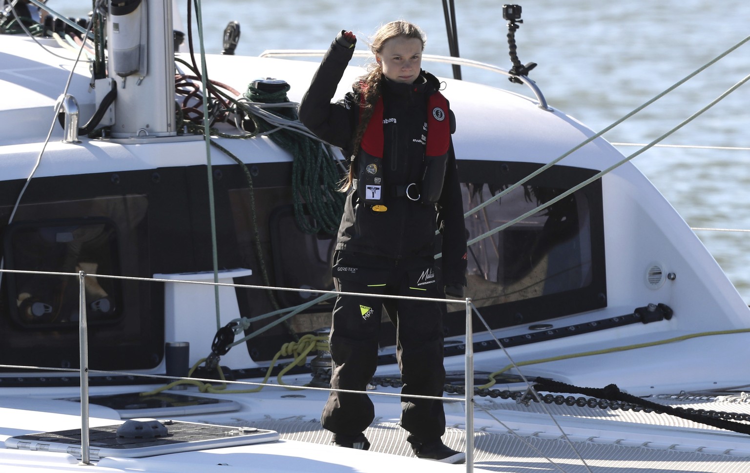 Climate activist Greta Thunberg waves as she arrives in Lisbon aboard the sailboat La Vagabonde Tuesday, Dec 3, 2019. Thunberg has arrived by catamaran in the port of Lisbon after a three-week voyage  ...