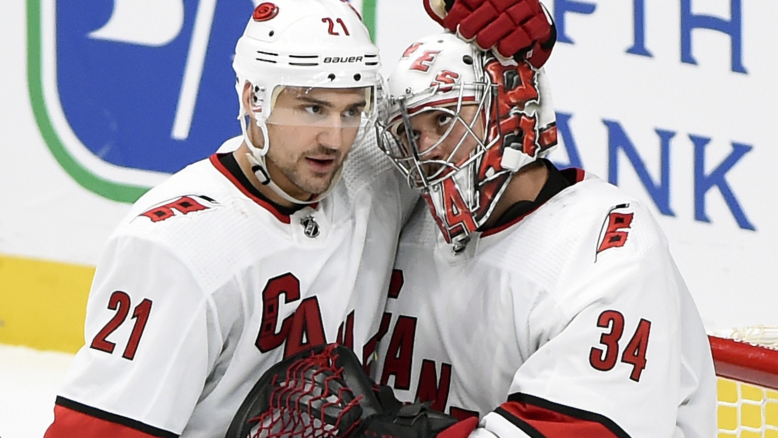 Carolina Hurricanes goaltender Petr Mrazek (34), of the Czech Republic, is congratulated by right wing Nino Niederreiter (21), of Switzerland, after the team's win against the Nashville Predators in a ...