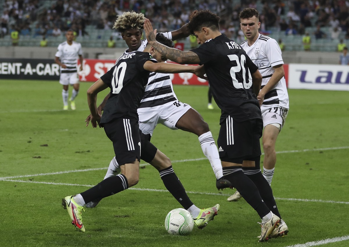 Basel's Andy Pelmard, centre, fights for the ball with Qarabag's Abdellah Zoubir, left, and Qarabag's Kady during the Europa Conference League, group H, soccer match between FK Qarabag  ...