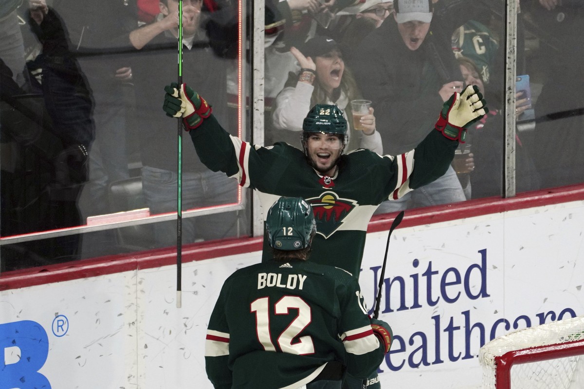 Minnesota Wild's Kevin Fiala, top, celebrates his game-tying goal off San Jose Sharks goalie James Reimer in the third period of an NHL hockey game, Sunday, April 17, 2022, in St. Paul, Minn. The ...