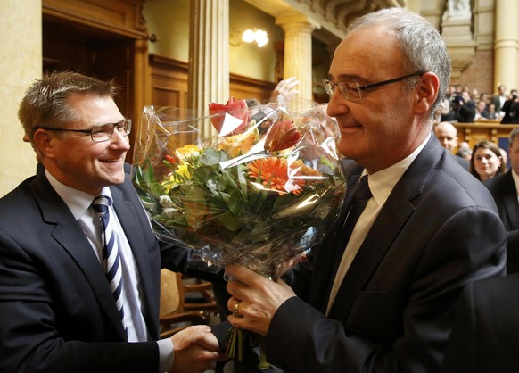 Swiss People&#039;s Party (SVP) President Toni Brunner (L) congratulates newly elected Federal Councillor Guy Parmelin (L) during the ministerial elections in the Swiss Parliament during the winter se ...