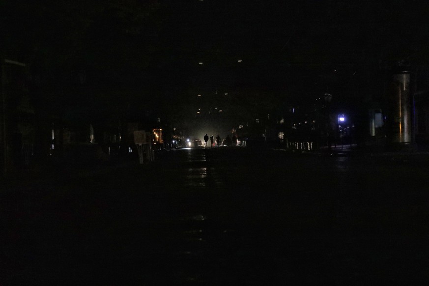 ODESA, UKRAINE - OCTOBER 25, 2022 - Pedestrians light their way with smartphone flashes, Odesa, southern Ukraine. Energy-saving practices and power cuts have been imposed in response to Russias contin ...
